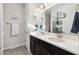 Modern bathroom with double sinks, a large mirror, and stylish lighting fixtures at 188 Olympus Way, Kissimmee, FL 34759