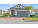 Lovely single-story home with a brick driveway, two-car garage, and well-maintained landscaping at 188 Olympus Way, Kissimmee, FL 34759