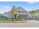 Attractive single-story home with a brick driveway, two-car garage, and mature trees at 188 Olympus Way, Kissimmee, FL 34759