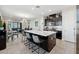 Modern kitchen featuring a large island, dark cabinets, and stainless steel appliances at 188 Olympus Way, Kissimmee, FL 34759