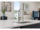 Close-up of a modern kitchen island with stainless steel faucet and fixtures at 188 Olympus Way, Kissimmee, FL 34759
