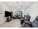 Cozy living room with comfortable leather seating, a media center, and plenty of natural light at 188 Olympus Way, Kissimmee, FL 34759