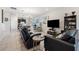 Open concept living space with modern furnishings, dining area, and a view into the kitchen at 188 Olympus Way, Kissimmee, FL 34759
