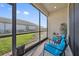 Screened in lanai with furniture and view of yard at 188 Olympus Way, Kissimmee, FL 34759