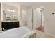 Bathroom featuring a soaking tub, dark wood cabinets, and tiled floors at 2015 Sandy Garden Ln, Winter Garden, FL 34787