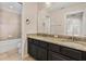 Bathroom featuring a double sink vanity with granite countertops and tiled shower/tub at 2015 Sandy Garden Ln, Winter Garden, FL 34787