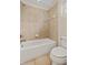 Well-lit bathroom showcasing a white tiled tub-shower combination and a matching toilet at 2015 Sandy Garden Ln, Winter Garden, FL 34787