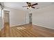 Clean bedroom featuring laminate floors, ceiling fan, and ensuite access at 2015 Sandy Garden Ln, Winter Garden, FL 34787