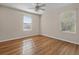 This bedroom features wood-look flooring and two windows offering ample natural light at 2015 Sandy Garden Ln, Winter Garden, FL 34787