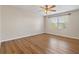 Bright bedroom with wood-look flooring, ceiling fan, and natural light from the large window at 2015 Sandy Garden Ln, Winter Garden, FL 34787