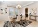 Formal dining area with a chandelier, decorative rug, arched doorway, and views into the kitchen at 2015 Sandy Garden Ln, Winter Garden, FL 34787