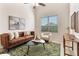 Bright living room with modern decor, high ceilings, tile flooring, contemporary furnishings, and large window with blinds at 2015 Sandy Garden Ln, Winter Garden, FL 34787
