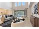 Bright living room showcasing a large sliding door, high ceilings, neutral tones, and views into the backyard at 2015 Sandy Garden Ln, Winter Garden, FL 34787