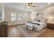 Bright main bedroom featuring hardwood floors, a ceiling fan, and plantation shutters at 2015 Sandy Garden Ln, Winter Garden, FL 34787