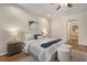 Well-lit main bedroom boasts hardwood floors, ceiling fan, and ensuite bath at 2015 Sandy Garden Ln, Winter Garden, FL 34787