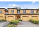 Inviting townhome featuring a two-car garage and well-maintained landscaping at 2040 Retreat View Cir, Sanford, FL 32771