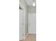 Hallway with neutral walls leading to white paneled doors and tiled flooring at 2040 Retreat View Cir, Sanford, FL 32771