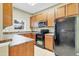 Well-lit kitchen with stainless steel microwave, electric range, and refrigerator at 2040 Retreat View Cir, Sanford, FL 32771
