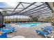 Community pool with lounge chairs and a screened enclosure at 2040 Retreat View Cir, Sanford, FL 32771