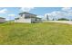 Spacious backyard featuring a pristine white fence and lush green grass at 2097 Rosewood Dr, Bartow, FL 33830