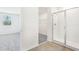 Bathroom features a glass-enclosed shower, wood-style tile floor, and doorway to bedroom and closet at 2097 Rosewood Dr, Bartow, FL 33830