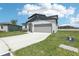 Well-maintained home featuring a two-car garage, manicured lawn, and an attractive architectural design at 2097 Rosewood Dr, Bartow, FL 33830
