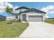 Charming two-story home with a two-car garage, lovely front yard, and inviting curb appeal at 2097 Rosewood Dr, Bartow, FL 33830