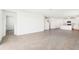 Open-concept living area with a view into the kitchen and stylish flooring at 2097 Rosewood Dr, Bartow, FL 33830