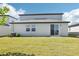 Backyard featuring a well-maintained lawn and sliding glass doors leading to indoor living areas at 2098 Rosewood Dr, Bartow, FL 33830