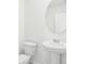 Cozy bathroom showcases a pedestal sink and toilet with clean, white tile flooring at 2098 Rosewood Dr, Bartow, FL 33830