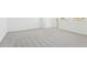 Carpeted bedroom with white walls and baseboards and two large windows at 2098 Rosewood Dr, Bartow, FL 33830