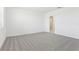 Bright bedroom with neutral walls, soft carpet, and a view of a walk-in closet at 2098 Rosewood Dr, Bartow, FL 33830