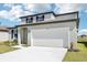 Attractive home showcasing a two-car garage, landscaped front yard, and modern architectural details at 2098 Rosewood Dr, Bartow, FL 33830