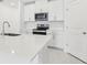 Bright kitchen with white cabinets, stainless steel microwave, and a center island for cooking at 2098 Rosewood Dr, Bartow, FL 33830