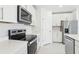 Modern kitchen with stainless steel appliances, white countertops and cabinets providing ample storage at 2098 Rosewood Dr, Bartow, FL 33830