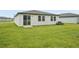 Backyard view with a sliding glass door leading to the grassy lawn at 2105 Rosewood Dr, Bartow, FL 33830