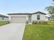 Charming one-story home with a well-manicured lawn and a light-blue front door at 2105 Rosewood Dr, Bartow, FL 33830