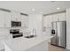 Well-lit kitchen featuring stainless steel appliances, quartz countertops and white cabinets at 2105 Rosewood Dr, Bartow, FL 33830