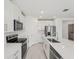 Bright kitchen with stainless steel appliances, island and white cabinetry at 2105 Rosewood Dr, Bartow, FL 33830