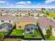 Aerial view of a tan two-story home featuring a screened patio and a fenced yard with nearby lake views at 211 Lazio Cir, Debary, FL 32713