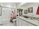 Bathroom featuring a double vanity with granite counters and a shower-tub combo at 211 Lazio Cir, Debary, FL 32713