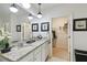Bright bathroom featuring a double vanity with granite countertop and a walk-in closet at 211 Lazio Cir, Debary, FL 32713