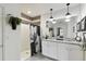 Modern bathroom with a double vanity, granite countertop, stylish light fixtures, and a walk-in shower at 211 Lazio Cir, Debary, FL 32713