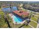 Aerial view of a large community pool with lounge chairs and tropical landscaping at 211 Lazio Cir, Debary, FL 32713
