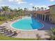 Expansive community pool with lounge chairs and lush palm trees at 211 Lazio Cir, Debary, FL 32713