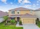 Lovely two-story home with a well-maintained lawn and an attached two-car garage at 211 Lazio Cir, Debary, FL 32713