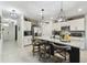 Modern kitchen features a large center island with seating, stainless steel appliances, and elegant pendant lighting at 211 Lazio Cir, Debary, FL 32713