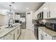 Well-equipped kitchen with stainless steel appliances, granite countertops, white cabinetry and tile flooring at 211 Lazio Cir, Debary, FL 32713