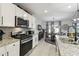 Open-concept kitchen flowing into dining area featuring granite countertops, stainless steel appliances and lots of cabinet space at 211 Lazio Cir, Debary, FL 32713