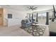 Upstairs living room with a comfortable couch, TV, and decorative accents at 211 Lazio Cir, Debary, FL 32713